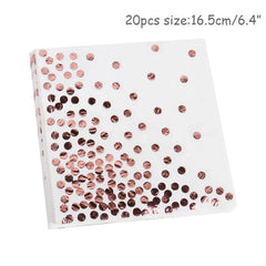 A stack of white paper napkins decorated with a rose gold foil polka dot pattern.
