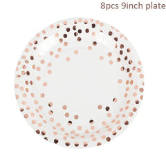 A nine-inch white paper plate decorated with a rose gold polka dot confetti pattern.