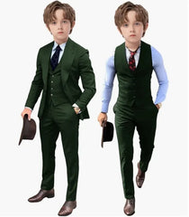 A boy wearing a dark green three-piece suit with a vest, jacket, and matching trousers.