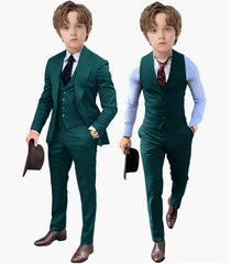 A boy wearing a dark green three-piece suit with a vest, jacket, and trousers.