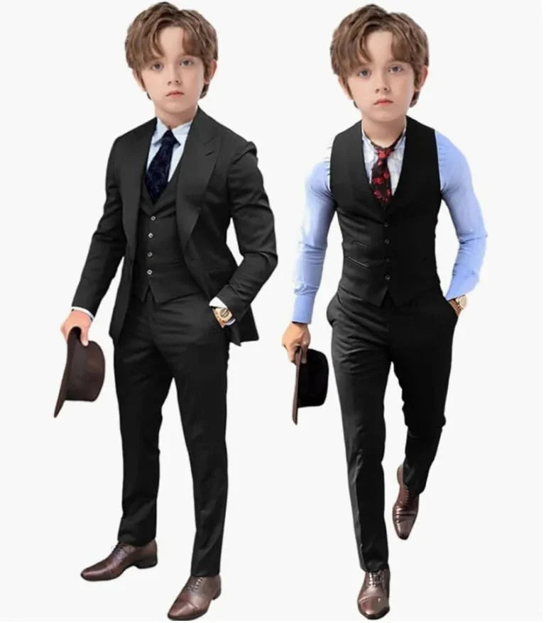 A young boy models a black three-piece suit set including a jacket, vest, and trousers.