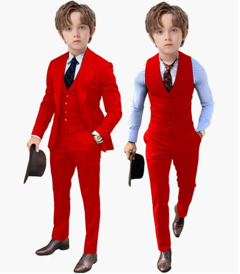 A young boy models a red three-piece suit consisting of a blazer, vest, and trousers.