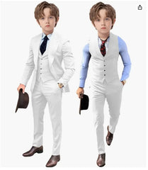 A boy wearing a white three-piece suit with a light blue shirt and a dark tie.
