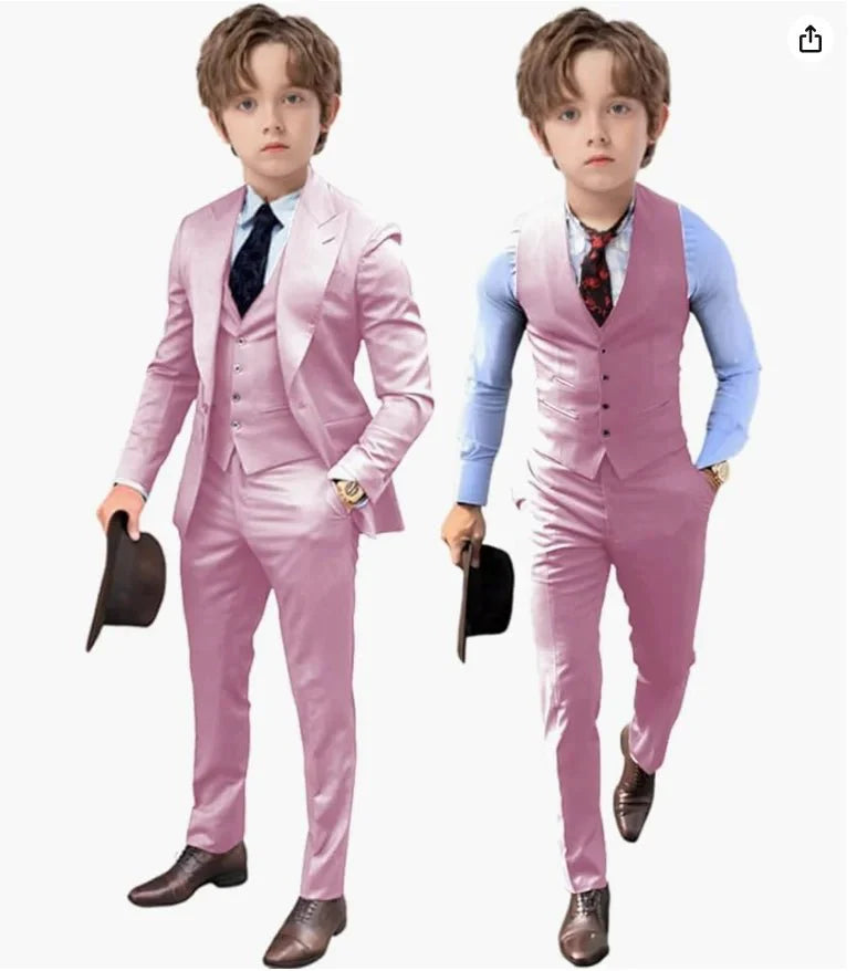 Two boys wearing matching pink three-piece suits with vests, dress shirts, and ties.