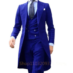 A man wears a royal blue three-piece suit featuring a long tail coat, waistcoat, and trousers.