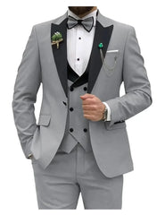 A light gray three-piece suit featuring a black shawl lapel, a double-breasted vest, and a bowtie.