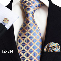 A blue and gold plaid necktie, pocket square, and matching cufflink set for men.