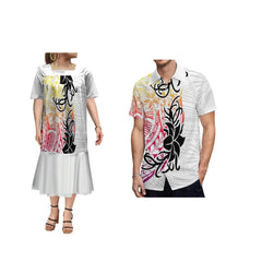 A woman in a white ruffle-bottom dress and a man in a matching short-sleeve shirt with Polynesian prints.