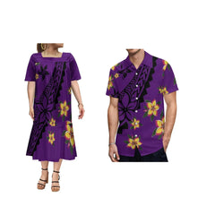 A woman in a purple floral dress and a man in a matching purple floral shirt.