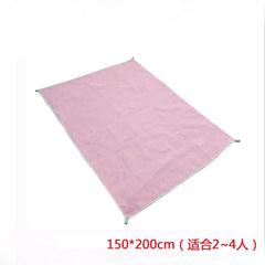 A rectangular pink sand-free beach mat measuring 150 by 200 centimeters.