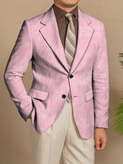 A man wears a slim-fit purple blazer with a white floral print and two dark buttons.