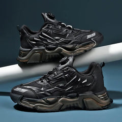 Two black luxury shoes men Sneakers with geometric patterns, thick textured soles, and silver accents are displayed side by side on a white rod against a dark background. These lace-free Trainer Race fashion loafers have a sporty, futuristic look.