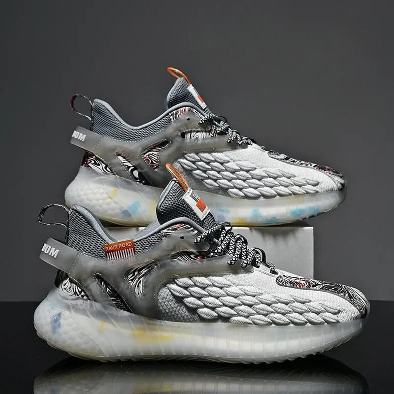 A pair of men's luxury sneakers, featuring gray and white uppers with textured patterns and chunky translucent soles, displayed side by side—one resting on a box. Product: shoes men Sneakers Male Mens casual Shoes tenis Luxury shoes Trainer Race Lace-free Shoes fashion loafers running Shoes for men.