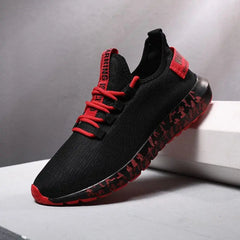 A black men's luxury sneaker with red accents and a red-and-black patterned sole is shown on a white surface, ideal for fans of shoes men Sneakers Male Mens casual Shoes or height increasing sneakers.