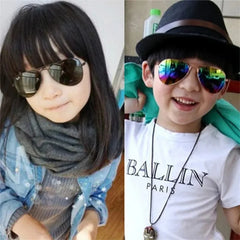 A young boy and girl wearing stylish metal-framed pilot sunglasses with mirrored lenses.