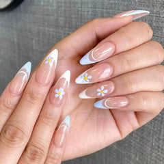 Almond-shaped press-on nails featuring a French tip design with delicate white floral accents.