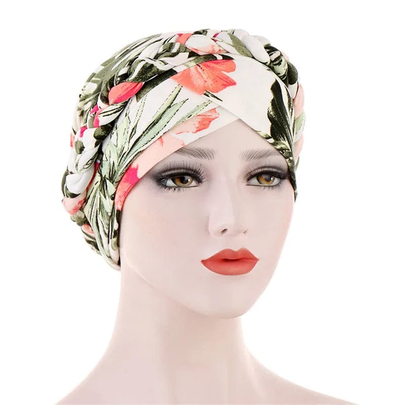 A mannequin wears a floral-patterned cotton turban with a braided headband detail.