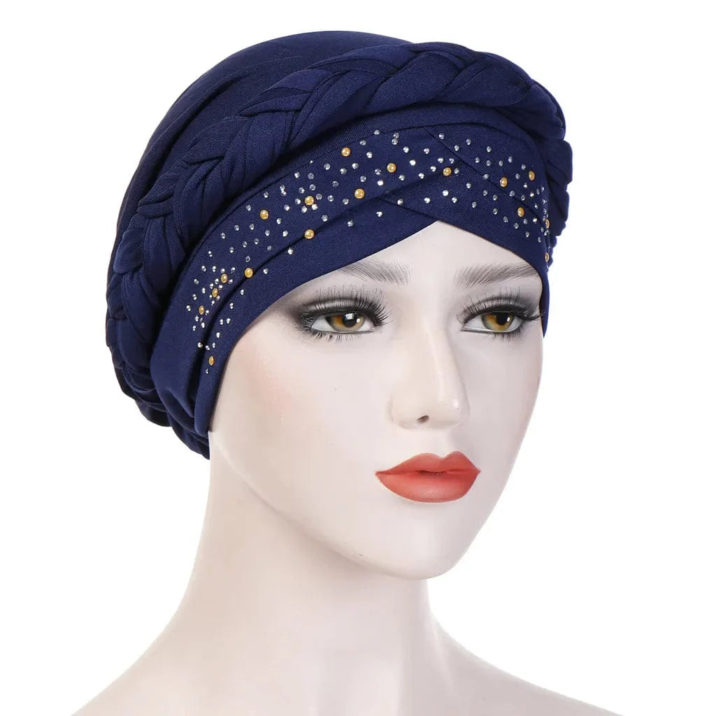 A navy blue cotton turban featuring a braided headband and pearl embellishments.