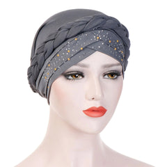 A grey cotton turban hijab for women featuring a braided headband and pearl embellishments.