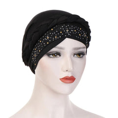 A black cotton turban head scarf featuring a braided band and scattered pearl embellishments.