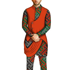 A man wears a traditional African two-piece set featuring a solid orange tunic and patterned pants.