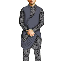 A man wears a grey vest over a black and white patterned long-sleeve shirt and matching pants.