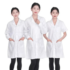 Three women wearing white medical lab coats with front pockets and button closures.