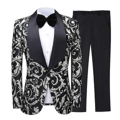 A black and silver floral patterned tuxedo blazer with a black shawl lapel, paired with black trousers.