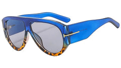 Oversized pilot sunglasses featuring a blue frame with leopard print accents and gradient lenses.