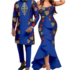A couple wears matching blue outfits featuring heart-patterned fabric and solid blue accents.