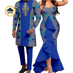 A man and woman wearing matching blue and patterned African-style outfits for a wedding.