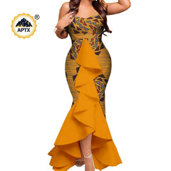 A woman wears a yellow mermaid-style dress with a geometric print and a large ruffled front panel.