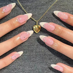 Long almond-shaped press-on nails with a pink base, white French tips, and small pearl accents.