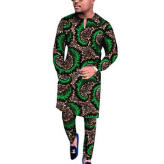 A man wears a long-sleeved V-neck shirt and matching trousers featuring a green and brown print.