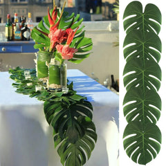 Artificial monstera leaves used as a tropical table runner for party decor.