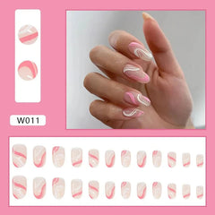A set of almond-shaped press-on nails featuring a pink and white wavy abstract design.