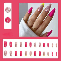 A set of twenty-four almond-shaped press-on nails featuring pink, floral, and yellow-tipped designs.