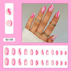 A set of almond-shaped press-on nails featuring a pink and white wavy design with small dots.