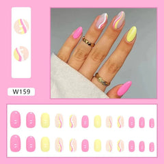 A set of almond-shaped press-on nails featuring a mix of solid pink, yellow, and wavy designs.