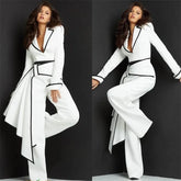 A woman wears a white jumpsuit with a blazer-style bodice, black trim, and a draped side panel.