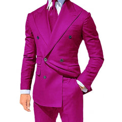 A man wears a vibrant magenta double-breasted suit with a matching tie and white dress shirt.