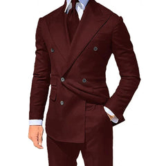 A man wears a dark burgundy double-breasted suit with a white shirt and matching tie.