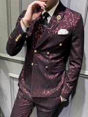 A man wears a slim-fit, double-breasted burgundy suit with a textured abstract pattern and gold buttons.