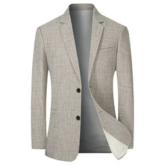 A light beige, single-breasted men's blazer with a subtle textured pattern and two front buttons.