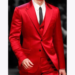 A slim fit three-piece red satin suit featuring a jacket, waistcoat, and matching trousers.