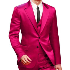 A man wears a slim fit magenta three-piece satin suit with a white shirt and black tie.