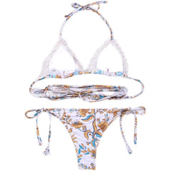 A white two-piece bikini with a blue and yellow floral print and hollow-out strap details.