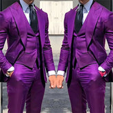 A man wears a vibrant purple three-piece suit featuring a peak lapel blazer, vest, and trousers.