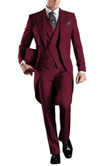 A man wears a burgundy three-piece tailcoat suit with a white shirt and patterned tie.