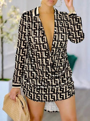 A woman wears a long-sleeve mini shirt dress featuring a black and beige geometric letter print.